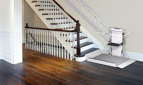 Inclined wheelchair lift on home stairwell